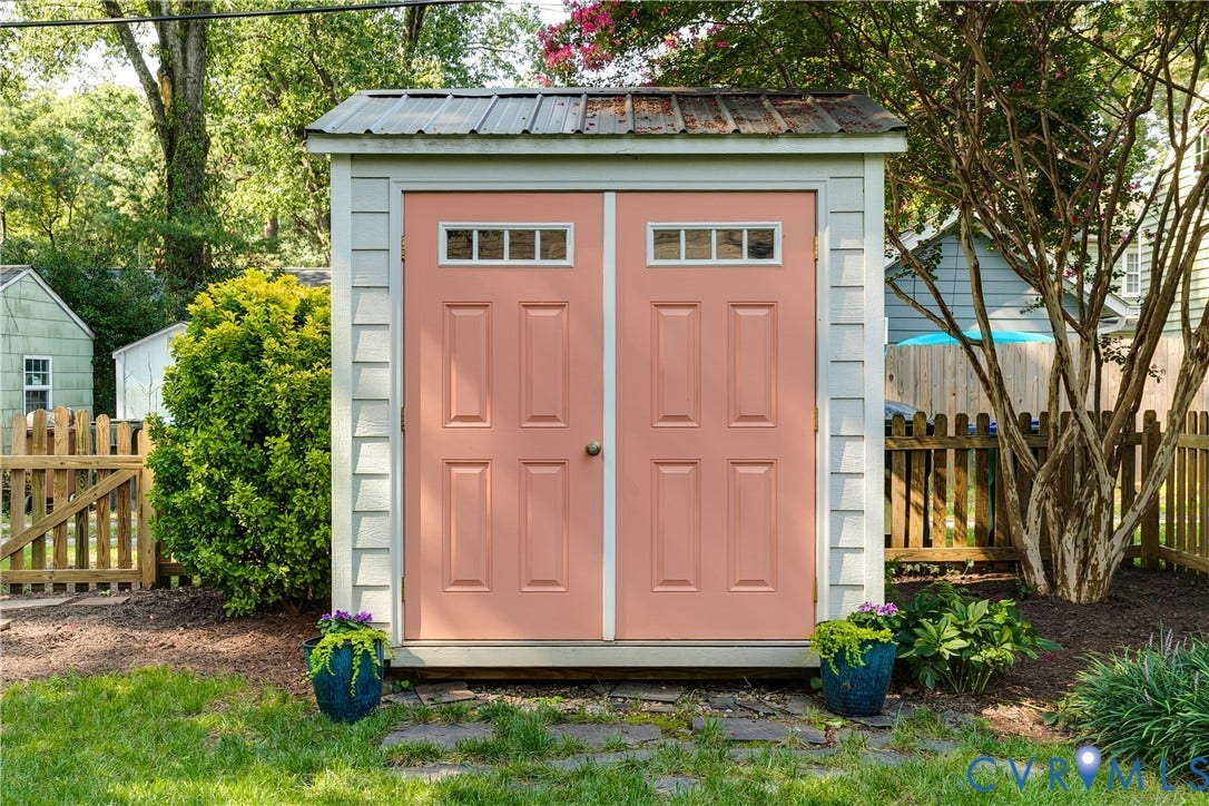 5204 Caledonia Road, Westover Hills, Richmond, VA 23225 Exterior storage shed featuring a metal roof, shingle siding, and double panel doors with transom windows