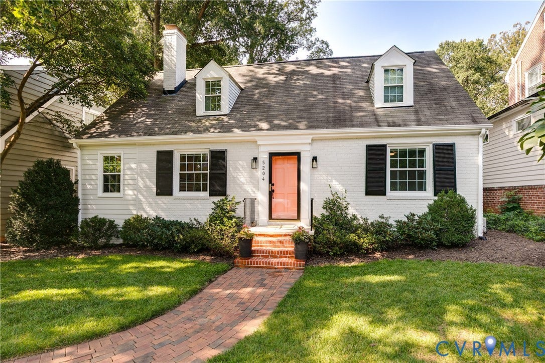 5204 Caledonia Road, Westover Hills, Richmond, VA 23225 White brick exterior with black shutters, dormer windows, and a vibrant coral front door