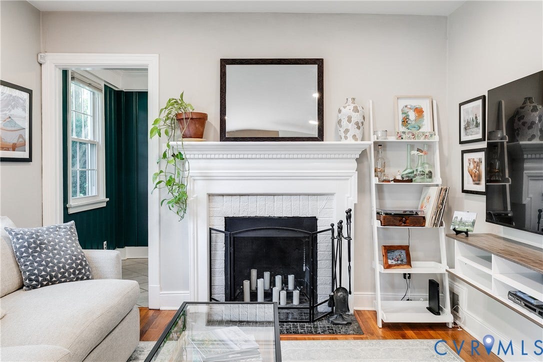 5204 Caledonia Road, Westover Hills, Richmond, VA 23225 Fireplace featuring a white mantel, white brick surround, and black fire screen