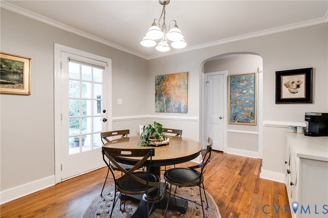 5204 Caledonia Road, Westover Hills, Richmond, VA 23225 Hardwood flooring, crown molding, chair rail molding, arched doorway, and a white built-in cabinet with a light-colored countertop