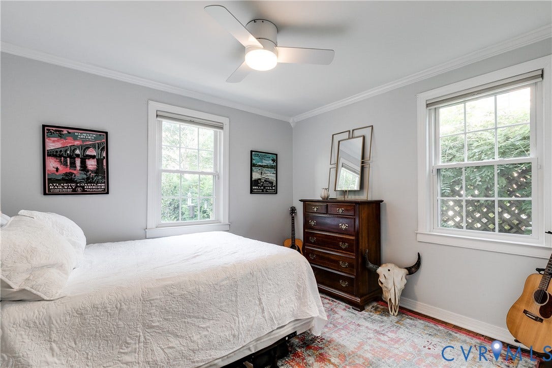 5204 Caledonia Road, Westover Hills, Richmond, VA 23225 Bright secondary bedroom with multiple windows flooding the space with natural light, hardwood flooring, ceiling fan with integrated lighting, and wood-finish dresser