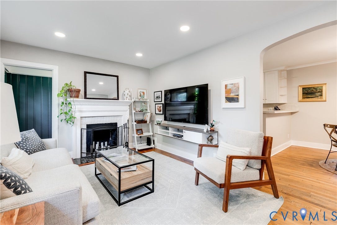 5204 Caledonia Road, Westover Hills, Richmond, VA 23225 Living area featuring a fireplace with a white mantel, recessed lighting, wood-finish flooring, and an arched doorway