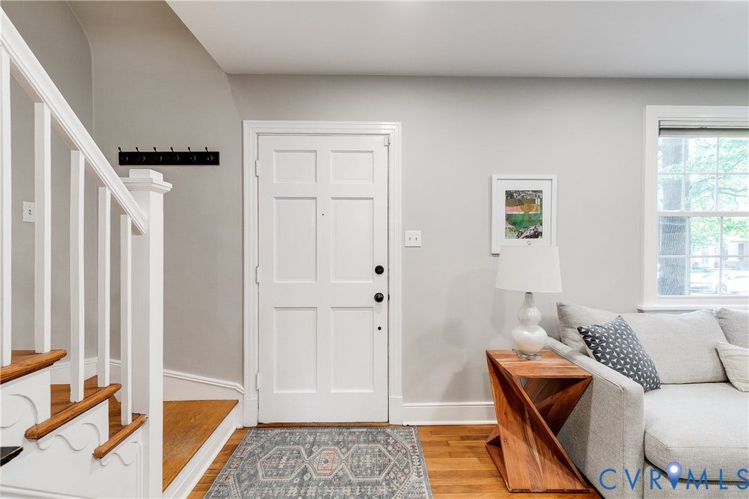 5204 Caledonia Road, Westover Hills, Richmond, VA 23225 Hardwood flooring, painted paneled door, staircase with white newel post and balusters, and a double-hung window