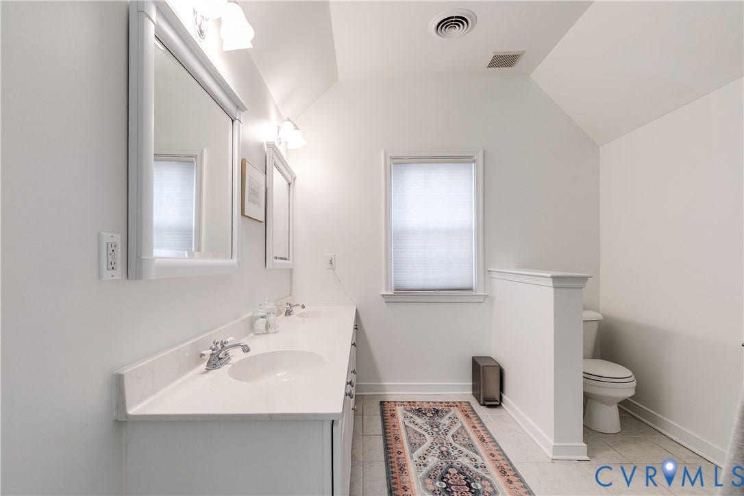 5204 Caledonia Road, Westover Hills, Richmond, VA 23225 Dual vanity with white cabinetry and integrated sinks, chrome fixtures, and individual mirrored medicine cabinets