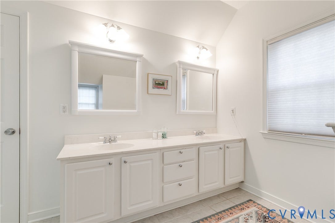 5204 Caledonia Road, Westover Hills, Richmond, VA 23225 Dual vanity with white cabinetry, integrated sinks, chrome fixtures, and white framed mirrors