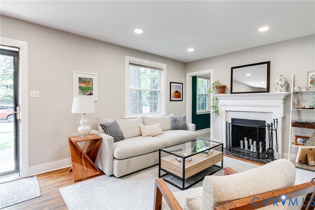 5204 Caledonia Road, Westover Hills, Richmond, VA 23225 Warm wood-finish flooring, recessed lighting, and a white fireplace with a dark tile hearth