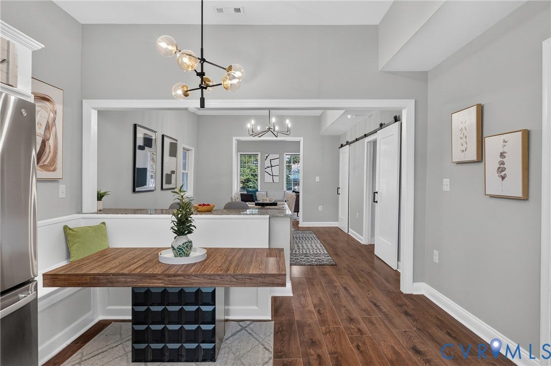 526 N 33rd Street, Church Hill, Richmond, VA 23223 LVP-finish flooring throughout, with a built-in banquette, overhead modern chandelier, and barn doors