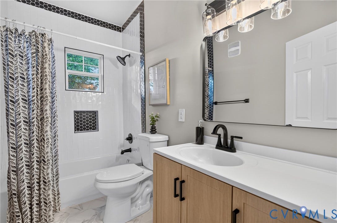 526 N 33rd Street, Church Hill, Richmond, VA 23223 White subway tile shower with a recessed niche, matte black fixtures, wood-finish vanity with a white countertop, and a large wall-mounted mirror