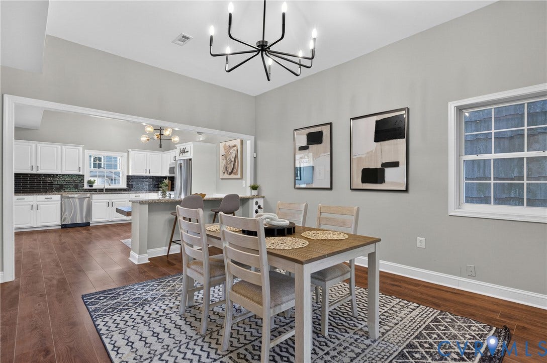 526 N 33rd Street, Church Hill, Richmond, VA 23223 Open-concept dining area featuring LVP-finish flooring, a contemporary chandelier, built in wine rack, sliding barn doors, and a pass-through to the kitchen