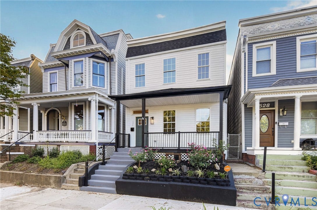 526 N 33rd Street, Church Hill, Richmond, VA 23223 White siding exterior with a black trim roofline, covered front porch, and a landscaped front planter