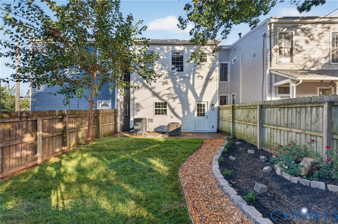 526 N 33rd Street, Church Hill, Richmond, VA 23223 Expansive backyard featuring a manicured lawn, a gravel pathway, and mature privacy fencing