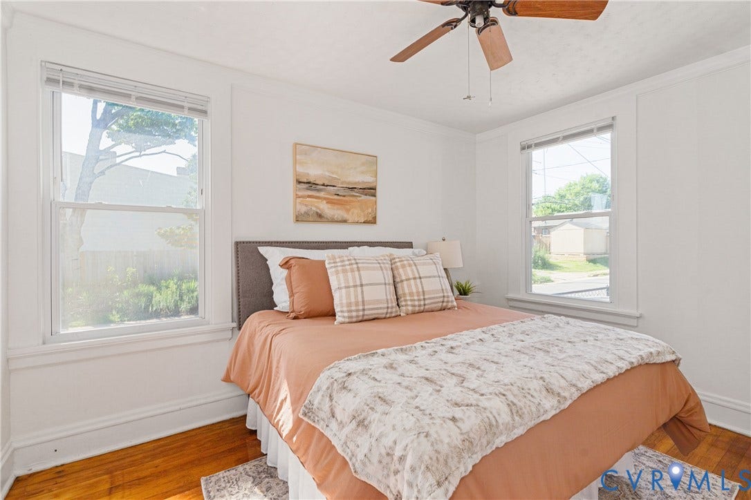 3401 Rosewood Avenue, Carytown, Richmond, VA 23221 Bedroom featuring hardwood flooring, white walls, two double-hung windows, and a ceiling fan with light fixture