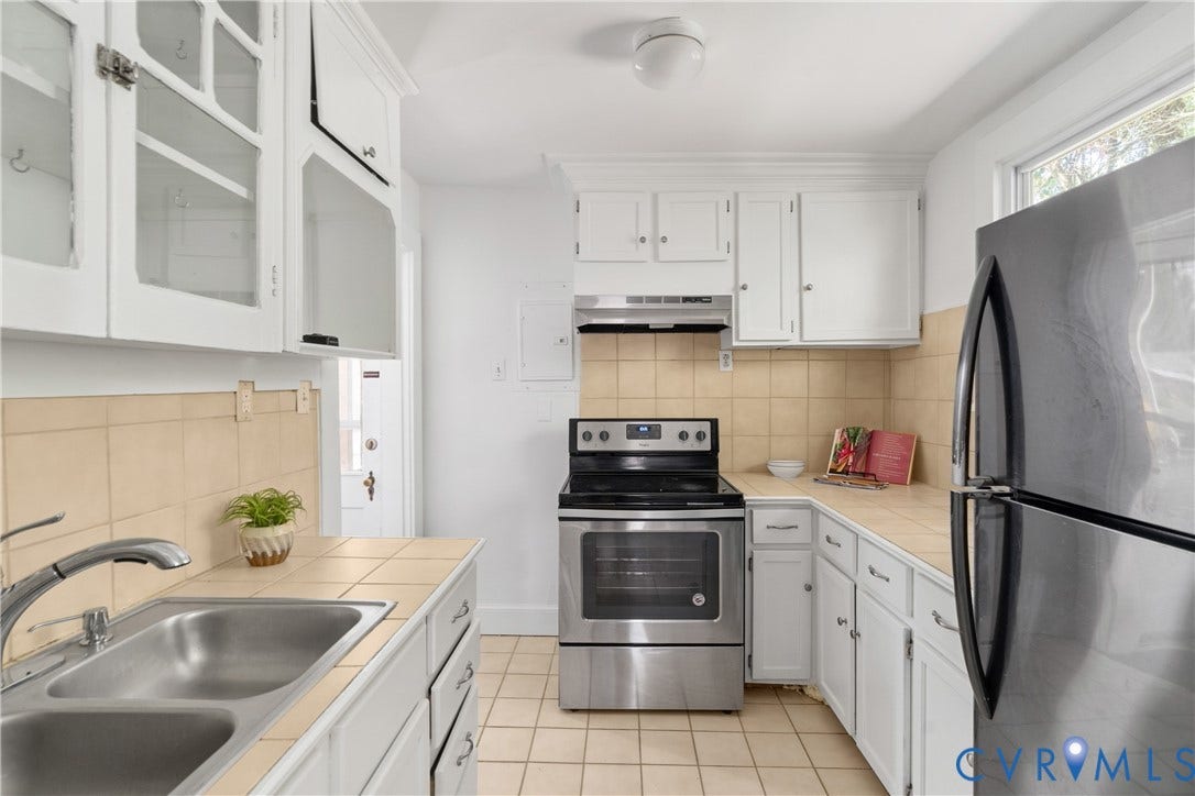 3401 Rosewood Avenue, Carytown, Richmond, VA 23221 Kitchen featuring white cabinetry with glass-front uppers, a double basin stainless steel sink, tiled countertops, a tiled backsplash, and stainless steel appliances including a range and refrigerator
