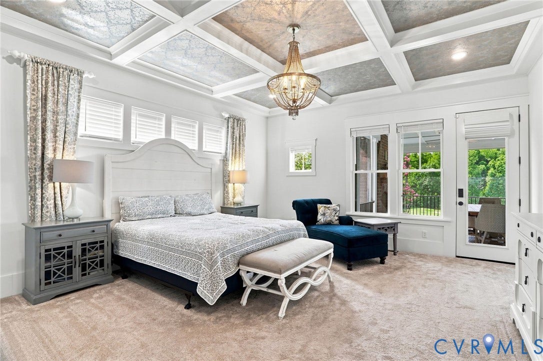 Coffered ceiling with decorative panels and central chandelier