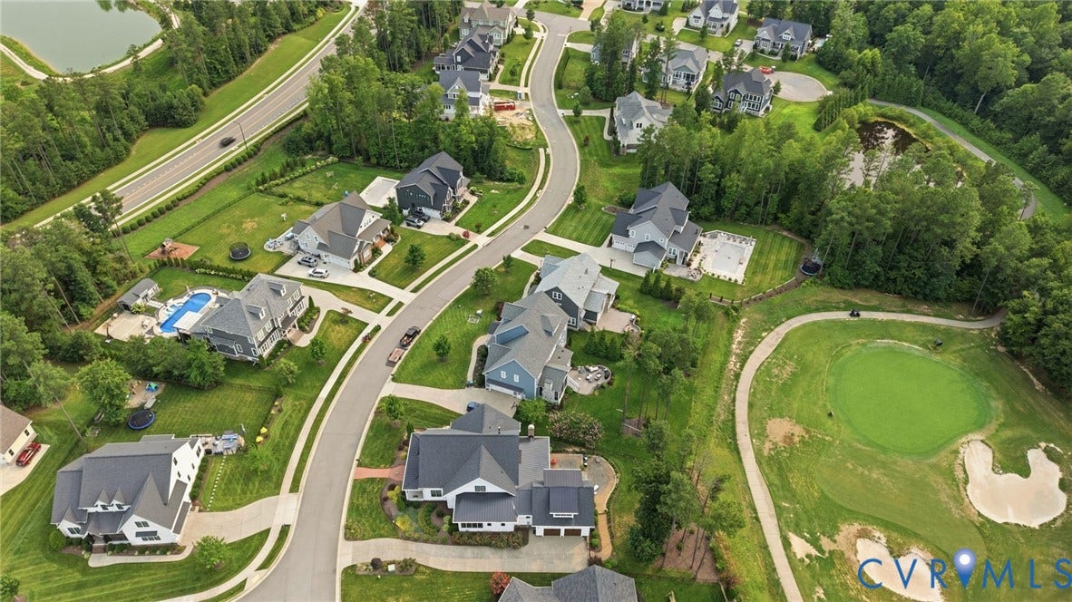Aerial perspective of a residential community featuring curving streets and multiple housing styles