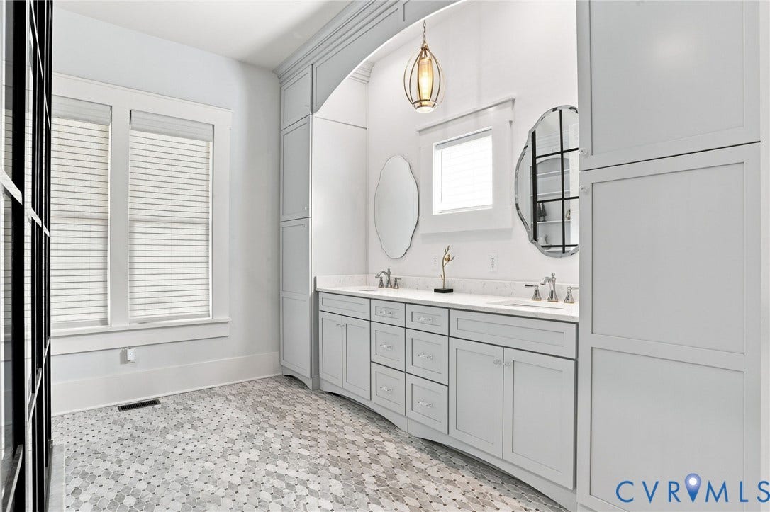 Double vanity with light gray cabinetry and white countertops