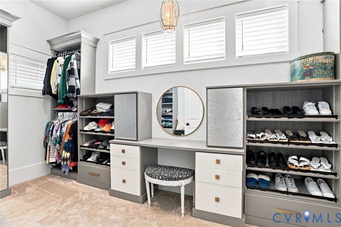 Custom closet system featuring built-in cabinetry, hanging rods, and integrated shoe shelving