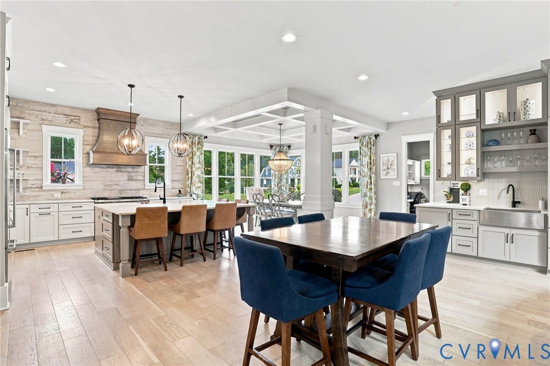 Open-concept kitchen and dining area with light wood-finish flooring
