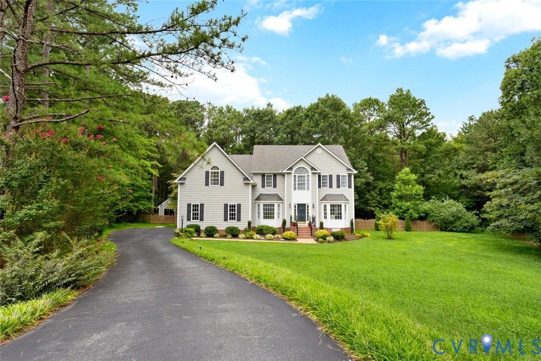 6001 Olde Hartley Place, Glen Allen, VA 23060 Two-story residence with light gray siding, dark shutters, and a prominent bay window