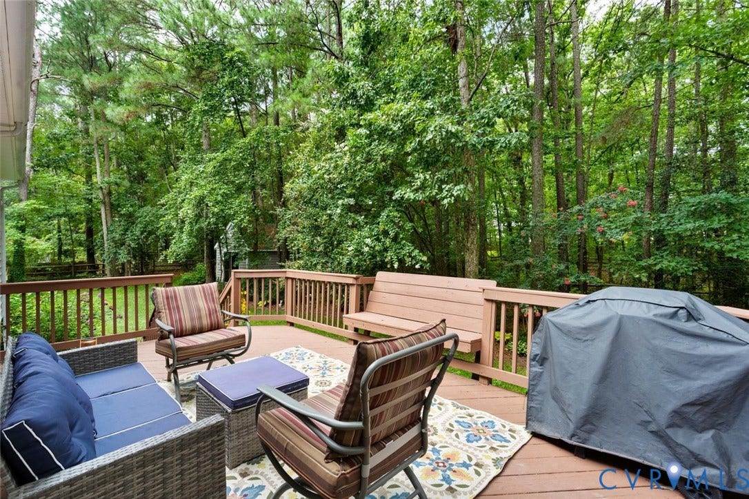 6001 Olde Hartley Place, Glen Allen, VA 23060 Expansive wood-finish deck with a built-in bench, surrounded by a lush, mature tree-filled landscape