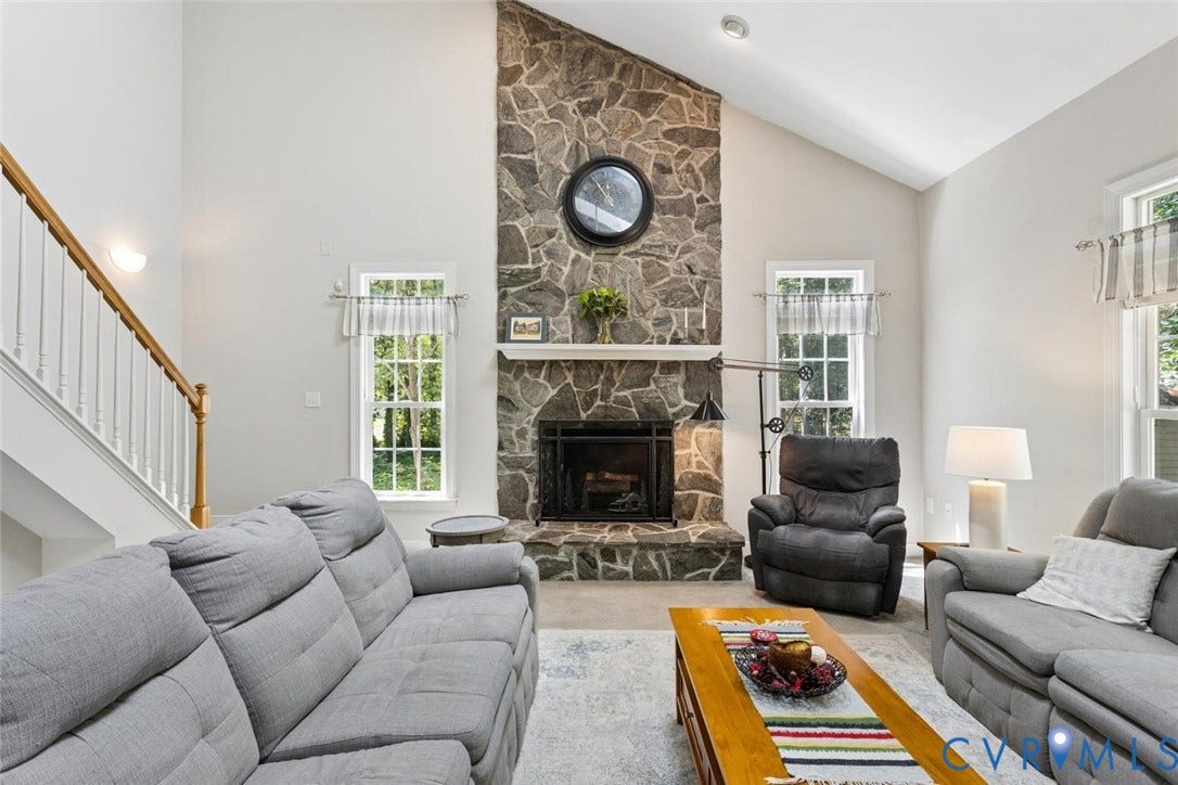 6001 Olde Hartley Place, Glen Allen, VA 23060 Vaulted ceilings with recessed lighting, stone fireplace with hearth, white-painted wood staircase with natural wood handrail, and multiple windows