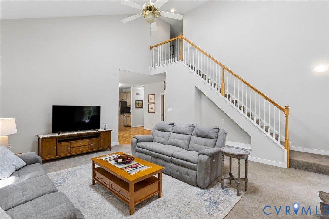 6001 Olde Hartley Place, Glen Allen, VA 23060 Vaulted ceiling with a ceiling fan, hardwood flooring, and a staircase with wood handrails
