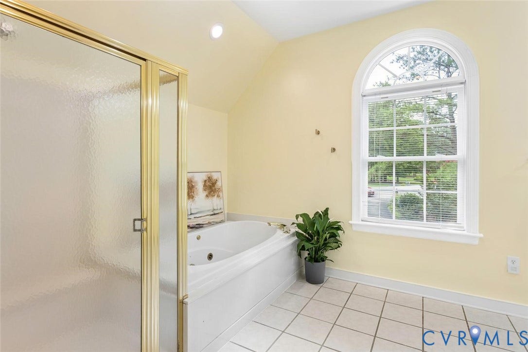 6001 Olde Hartley Place, Glen Allen, VA 23060 Frosted glass shower enclosure, white soaking tub with jets, arched window, white tile flooring, recessed lighting