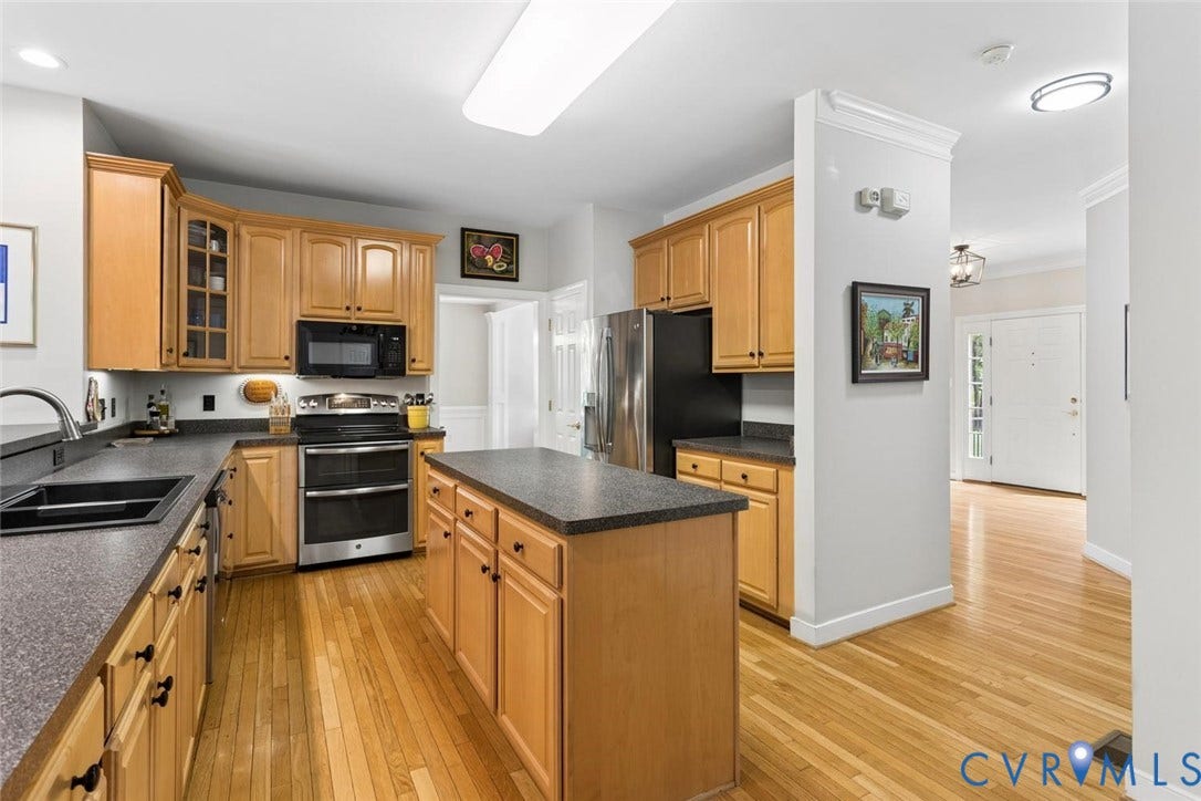6001 Olde Hartley Place, Glen Allen, VA 23060 Kitchen featuring wood-finish cabinetry, dark countertops, stainless steel appliances, and a central island