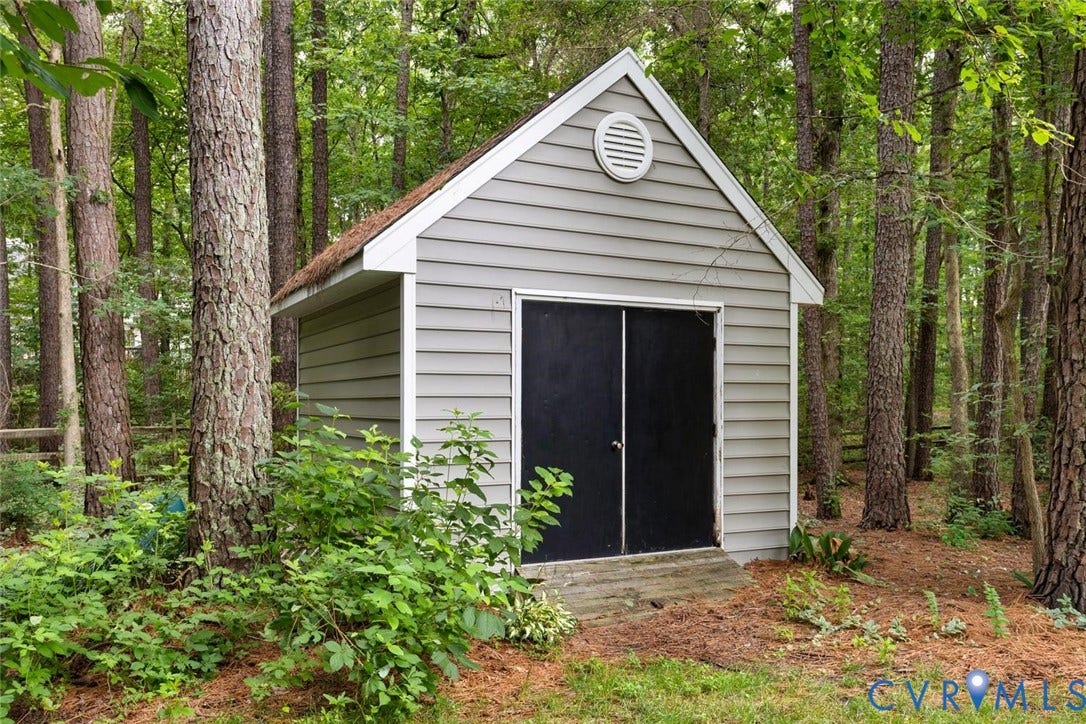 6001 Olde Hartley Place, Glen Allen, VA 23060 Wood-sided shed featuring a gable roof, louvered vent, and double doors