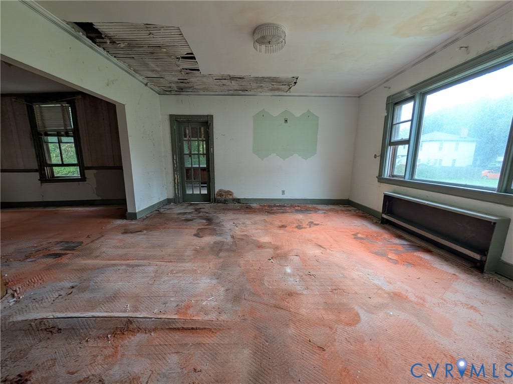 1409 Hungary Road, Richmond, VA 23228 Spacious interior with exposed subflooring, multiple large windows, and a partially open ceiling