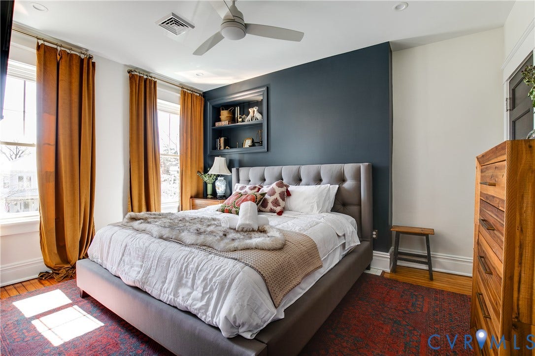 3142 Floyd Avenue, Museum District, Richmond, VA 23221 Bedroom featuring a dark accent wall with built-in shelving, hardwood flooring, and a ceiling fan