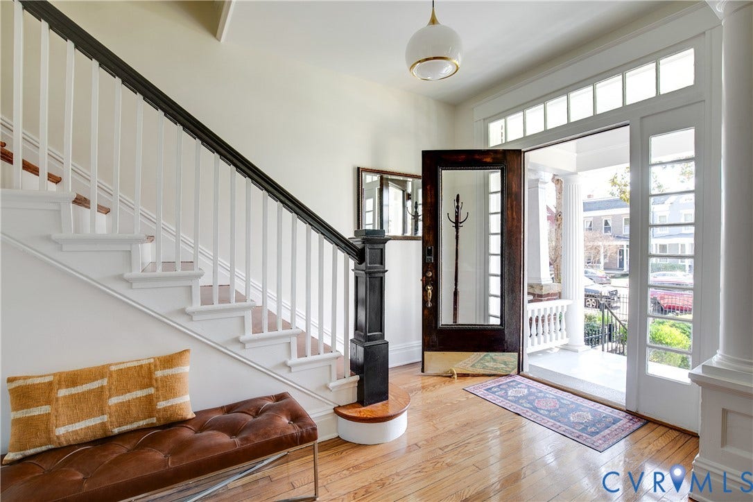 3142 Floyd Avenue, Museum District, Richmond, VA 23221 Foyer featuring wood-finish flooring, a white staircase with dark wood handrail, transom windows, sidelight windows, and a dark wood entry door