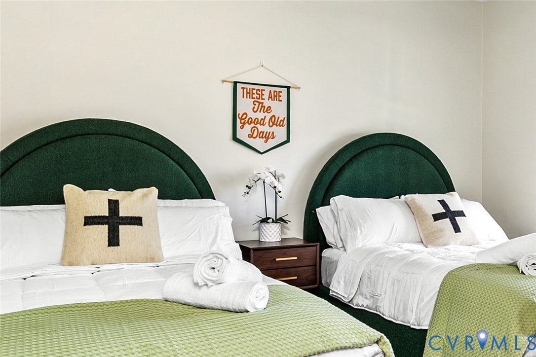 3142 Floyd Avenue, Museum District, Richmond, VA 23221 Two beds featuring arched green upholstered headboards, white bedding, and light green accent throws