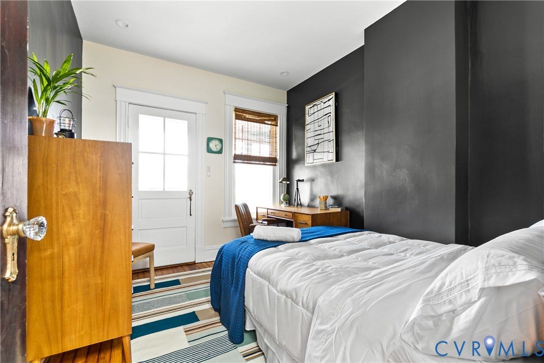3142 Floyd Avenue, Museum District, Richmond, VA 23221 Interior space featuring a white paneled door with glass inserts, a window with wood-finish blinds, and a dark accent wall