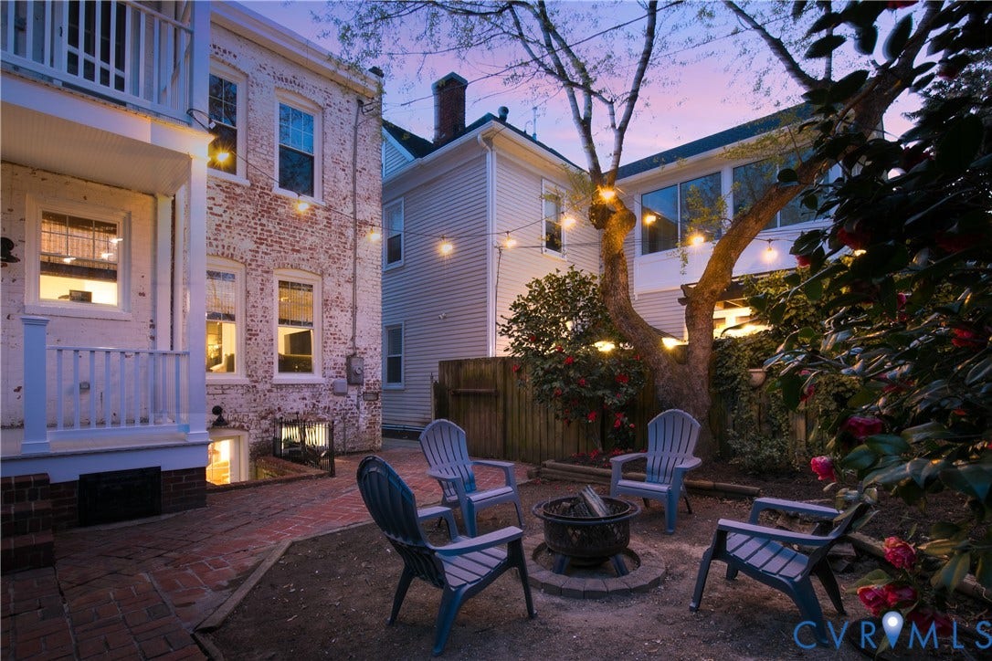 3142 Floyd Avenue, Museum District, Richmond, VA 23221 Private backyard featuring a brick patio and a central fire pit area