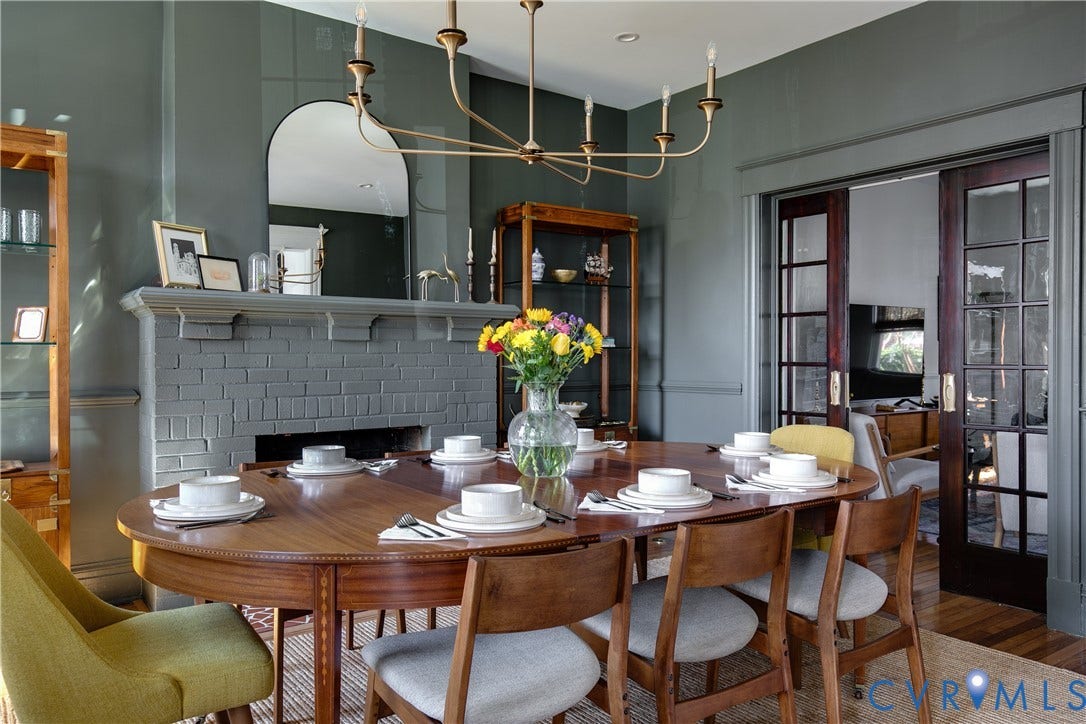 3142 Floyd Avenue, Museum District, Richmond, VA 23221 Dining area featuring a painted brick fireplace with a substantial mantelpiece and an arched mirror