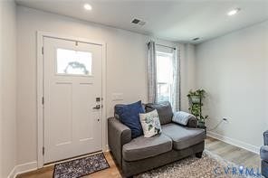 7225 Lyon Taylor Lane, The Groves At New Kent, New Kent, VA 23124 Entryway with a white paneled door featuring a clear glass insert, recessed lighting, wood-finish flooring, and a single window with curtains