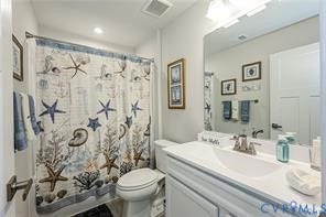 7225 Lyon Taylor Lane, The Groves At New Kent, New Kent, VA 23124 White vanity with integrated sink, rectangular mirror, and overhead light fixture