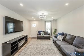 7225 Lyon Taylor Lane, The Groves At New Kent, New Kent, VA 23124 Spacious room featuring wood-finish flooring, recessed lighting, a decorative ceiling fixture, and a white entry door