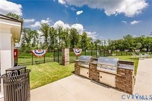 7225 Lyon Taylor Lane, The Groves At New Kent, New Kent, VA 23124 Outdoor grilling station featuring two built-in stainless steel grills, stone veneer base, and concrete countertop