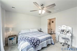 7225 Lyon Taylor Lane, The Groves At New Kent, New Kent, VA 23124 Spacious room featuring light gray carpeting, a ceiling fan with integrated lighting, and an open doorway revealing a bathroom with a vanity and toilet