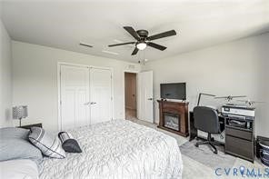7225 Lyon Taylor Lane, The Groves At New Kent, New Kent, VA 23124 Light-colored walls defining the room, featuring a ceiling fan with light fixture, double bi-fold closet doors, and a wood-finish electric fireplace