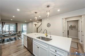 7225 Lyon Taylor Lane, The Groves At New Kent, New Kent, VA 23124 Kitchen island with an undermount sink and white cabinetry, stainless steel dishwasher, wood-finish flooring, recessed lighting, and a dining area