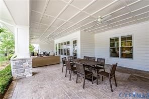 7225 Lyon Taylor Lane, The Groves At New Kent, New Kent, VA 23124 Spacious covered patio featuring a coffered ceiling, stamped concrete flooring, and stone-clad columns