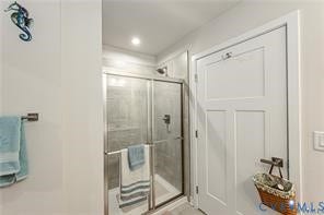 7225 Lyon Taylor Lane, The Groves At New Kent, New Kent, VA 23124 Shower with frameless glass enclosure and tiled walls, recessed lighting, and white paneled interior door