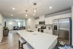 7225 Lyon Taylor Lane, The Groves At New Kent, New Kent, VA 23124 Spacious kitchen featuring a large central island, white cabinetry, stainless steel appliances, and sleek pendant lighting