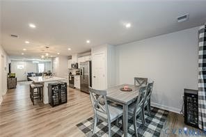 7225 Lyon Taylor Lane, The Groves At New Kent, New Kent, VA 23124 Open-concept living space featuring wood-finish flooring, recessed lighting, and a kitchen island with seating