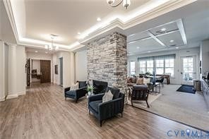 7225 Lyon Taylor Lane, The Groves At New Kent, New Kent, VA 23124 Spacious interior featuring wood-finish flooring, a stacked stone fireplace, tray ceilings with crown molding, and recessed lighting