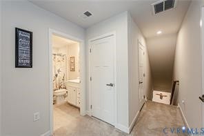 7225 Lyon Taylor Lane, The Groves At New Kent, New Kent, VA 23124 Hallway featuring light gray walls, neutral carpet flooring, recessed lighting, and a white interior door with contemporary hardware