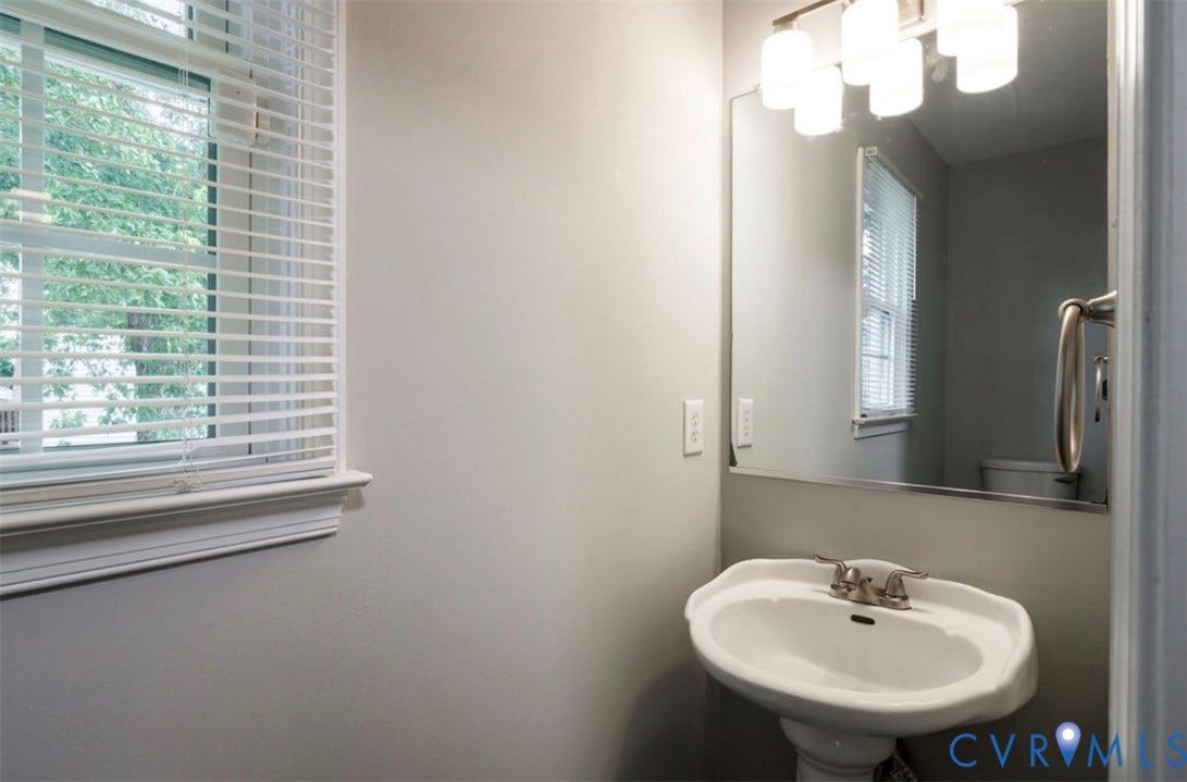 2912 Appleford Drive, Longmeadow, Chester, VA 23831 Pedestal sink with a dual-handle faucet, rectangular mirror, and a window with blinds